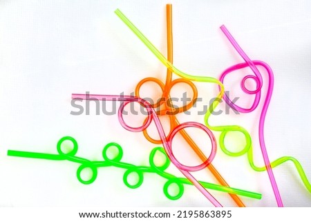 Fun and colorful crazy drinking straws for any occasion, isolated on white Royalty-Free Stock Photo #2195863895