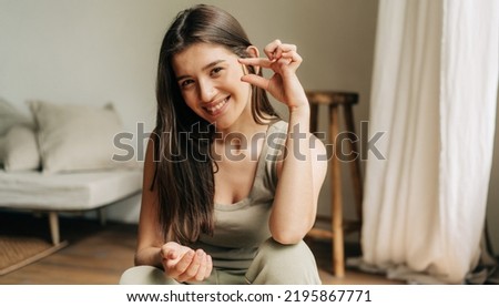 Beautiful caucasian healthy woman recommends vitamins and omega 3 oil Royalty-Free Stock Photo #2195867771