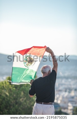 Senior man holding flag of Mexico. "September 16. Independence Day of Mexico.