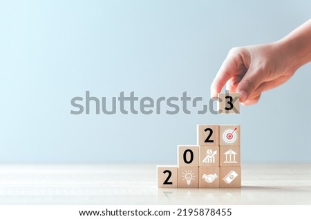 2023 Business development to success and growing growth concept.business strategy, Action plan, Goal and target, hand stack woods block step on table with icon about business strategy and Action plan. Royalty-Free Stock Photo #2195878455