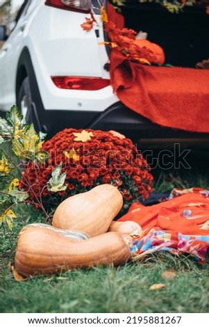 autumn decor with pumpkin and red plaid on the background of white car yellow leaves. ready location for a photo shoot
