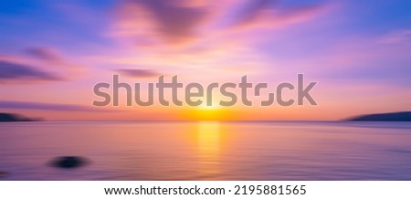 Blurred sea background at sunset, Abstract natural background and texture motion blur,panoramic view of sunrise over ocean.Dark sky sunlight and deep dark water sea background Royalty-Free Stock Photo #2195881565