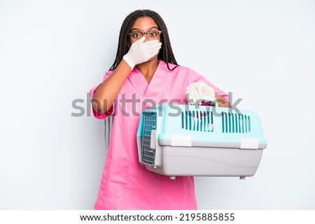 black pretty woman covering mouth with hands with a shocked. veterinarian concept