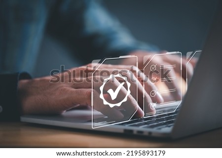 Businessman working on laptop with quality assurance inscription, Standard quality control certification assurance concept. Royalty-Free Stock Photo #2195893179