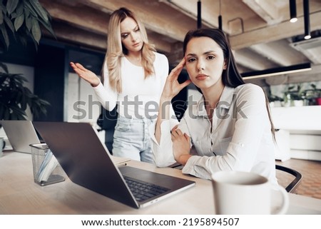 Young female boss scolding her female subordinate for bad work results Royalty-Free Stock Photo #2195894507