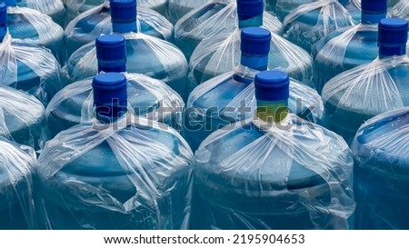 Large plastic bottles with clean water. Background picture.