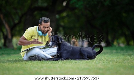 man teaching a dog in park,dog lover concept
