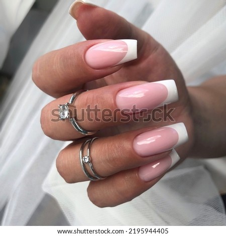 French manicure on the nails.Manicure gel nail polish. Spa and Manicure concept. Female hands with french manicure. Royalty-Free Stock Photo #2195944405