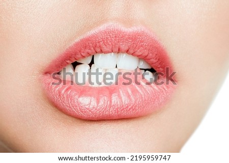 Woman's tongue seductively licking lips. Beautiful chubby lips. seduction concept. Royalty-Free Stock Photo #2195959747