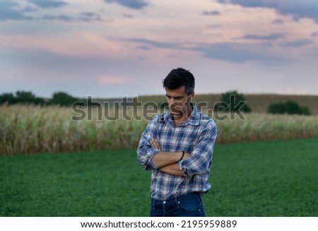 Worried and conceived farmer standing in field after dry season and feeling unhappy because of bad yield after drought Royalty-Free Stock Photo #2195959889
