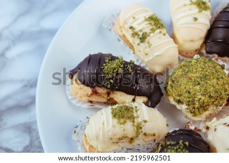 Eclairs with chocolate topping, delicious chocolate small cake, ekler pastry