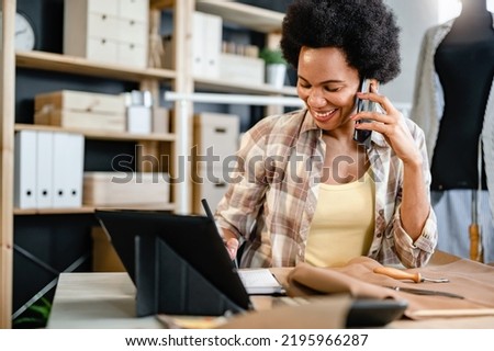 Black ethnicity entrepreneur young woman working in her small workshop. Female small business owner Royalty-Free Stock Photo #2195966287
