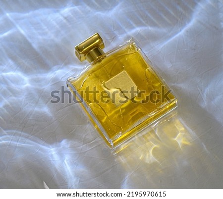 perfume golden bottle in the water