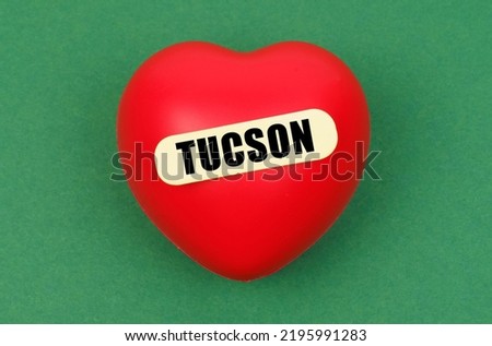 Love for the city, homeland. On a green surface lies a red heart with the inscription - Tucson
