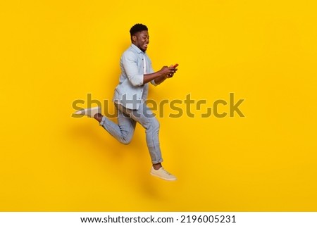 Full body profile side photo of guy use device search discounts jump rush fast copyspace isolated shine color background