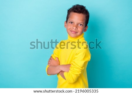 Profile side photo of nice cute boy dressed stylish yellow clothes outfit arm crossed empty space isolated on cyan color background