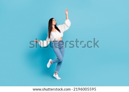 Full length photo of adorable peaceful person enjoy dancing isolated on blue color background