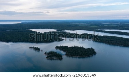 Aerial drone view of St. Mary's River between Lake Superior and Lake Huron with water channels passing through landscapes between Canada and The Unites States of America. Islands between countries. Royalty-Free Stock Photo #2196013549