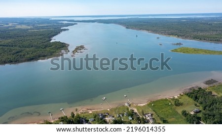 Wide open channel. Aerial drone view of St. Mary's River between Lake Superior and Lake Huron with water channels passing through landscapes between Canada and The Unites States of America. Royalty-Free Stock Photo #2196014355