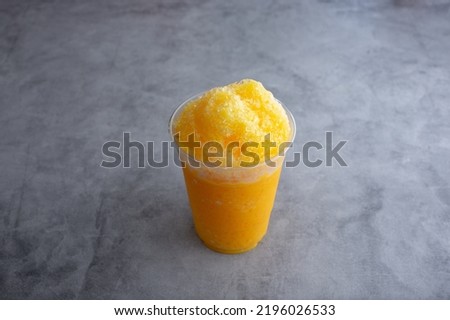 A view of a mango raspado beverage. Royalty-Free Stock Photo #2196026533