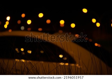 image of Abstract blurred bokeh background with warm colorful lights in the night. (vintage tone)