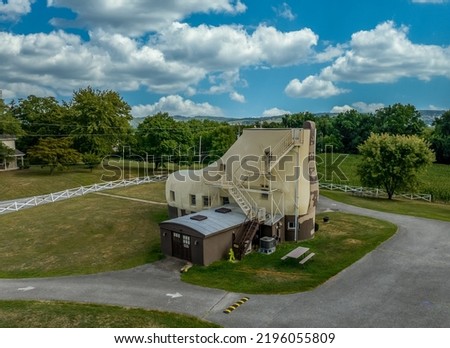 Aerial view of a shoe shape house in rural Pennsylvania near York with cloudy sky background