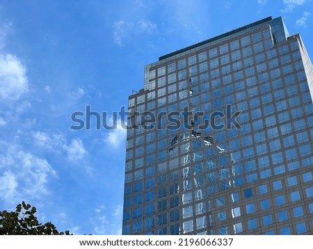 Manhattan and skyscrapers, architectural structures under blue sky in New York.