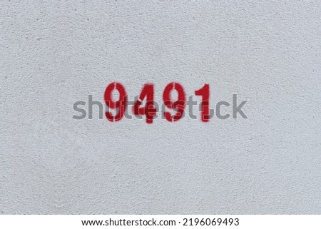 Red Number 9491 on the white wall. Spray paint.
