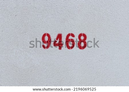 Red Number 9468 on the white wall. Spray paint.

