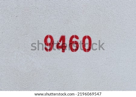 Red Number 9460 on the white wall. Spray paint.
