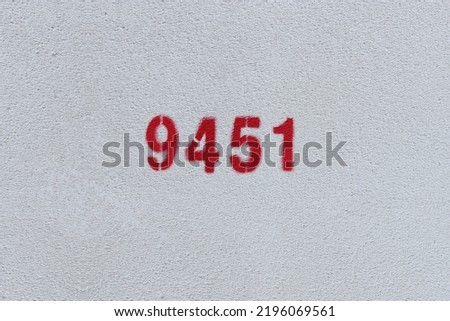 Red Number 9451 on the white wall. Spray paint.

