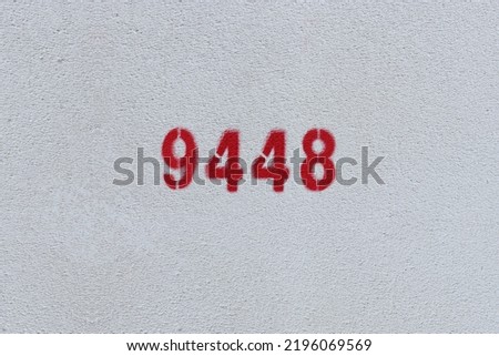 Red Number 9448 on the white wall. Spray paint.
