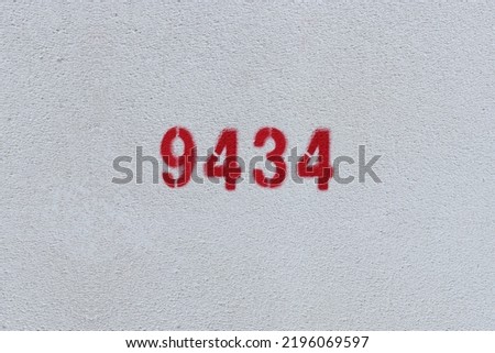 Red Number 9434 on the white wall. Spray paint.
