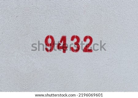 Red Number 9432 on the white wall. Spray paint.
