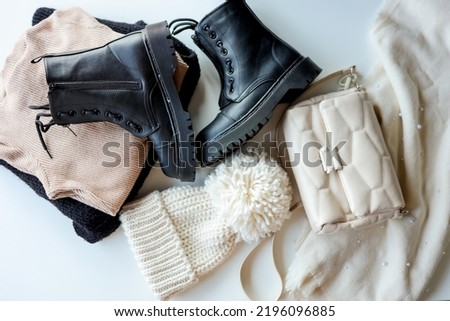 Autumn outfit with sweater, boots, hat, bag and scarf top view of autumn winter season outfit idea. Royalty-Free Stock Photo #2196096885