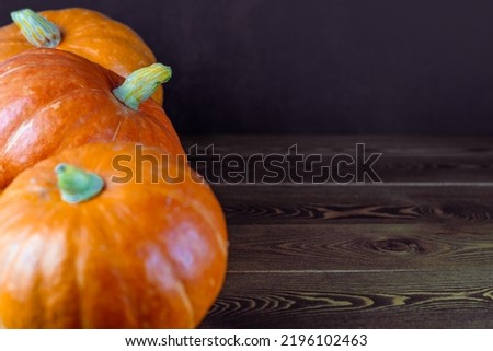 pumpkins on wooden table. Halloween and thanksgiving holiday and autumn harvest background
