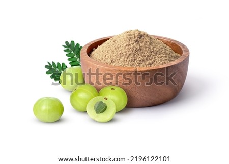 Amla powder (gooseberry flour) in  wooden bowl with fresh goose berry fruit isolated on white background.  Royalty-Free Stock Photo #2196122101