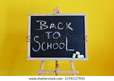 Blackboard - back to school. Concept for education and school on yellow background.  Flat Lay - Top View.