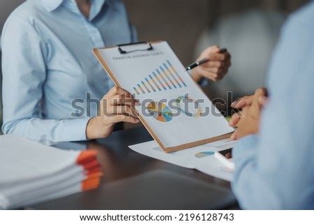 The business team jointly plan the investment at the meeting. Close-up of business advisor pointing to graph and analyzing financial report, balance sheet, financial statement. Royalty-Free Stock Photo #2196128743