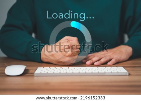 Man using a computer keyboard to download and waiting to loading digital business data form website, concept of waiting for load of loading bar.