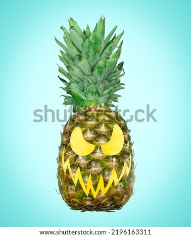 Pineapple with scary carved face on blue background. Creative minimal art Halloween poster.