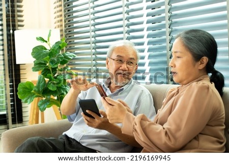Senior Elderly Couple has conversation together after retirement, Husband wife person has pension for romantic time with smile happy enjoy internet social media on digital smart phone, copy space