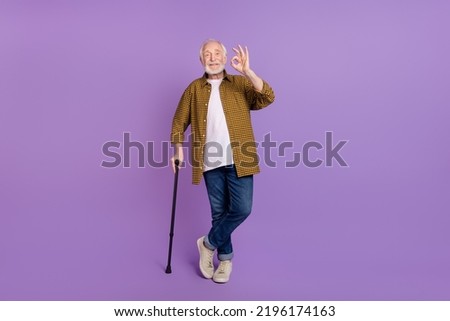 Full size photo of cheery granddad grey hair okey approve symbol wear stylish yellow plaid shirt isolated on lilac purple color background