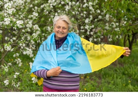 elderly woman with the flag of ukraine