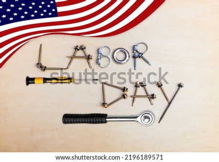 Labor day background idea, roofing screws arrangement on wood background with American flag 