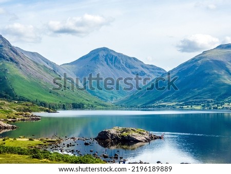 Wastwater is the deepest lake in England. Scafell Pike, the tallest mountain, can be seen in the distance. Royalty-Free Stock Photo #2196189889
