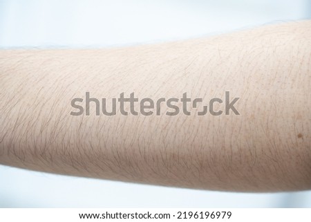 Close up of Asian man skin with arm hairy.(select focus)