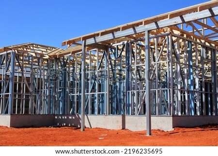 Metal and wood frame of a new modern house. No people. Copy space  Royalty-Free Stock Photo #2196235695