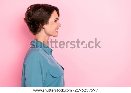 Profile photo portrait of cute young woman toothy smile look empty space banner dressed trendy blue look isolated on pink color background