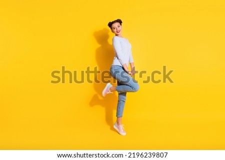 Full length photo of adorable dreamy girl dressed white shirt dancing isolated yellow color background